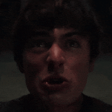 a close up of a man screaming with his mouth open