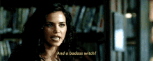 a woman says " and a badass witch " in front of a library