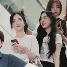 a group of girls are standing in front of a sign that says " peaches "