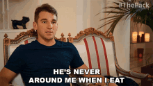a man sitting on a couch with the words he 's never around me when i eat