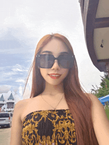 a woman wearing sunglasses and a strapless top