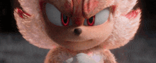 a close up of a stuffed animal with a red eye