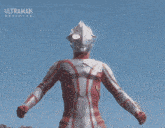 a close up of a person 's arm with a red and white striped armor