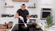 a man is stirring food in a pan with a spatula and a bag of knorr sauce in the background