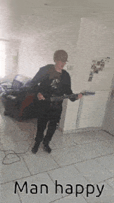 a man is playing a guitar in a living room with the words man happy above him