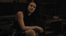 a woman sitting on a couch with her legs crossed