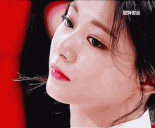 a close up of a woman 's face with a red background that says ' samsung '