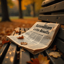 a newspaper titled euromillions lotto results on a park bench