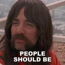 a man with long hair and a beard has the words people should be written on his face