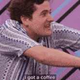 a man in a blue and white striped shirt is talking about having a coffee .