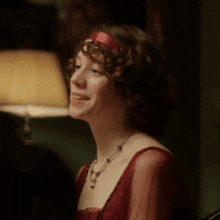 a woman in a red dress with a red headband