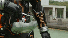 a person in a black and orange costume with the letter y on their sleeve