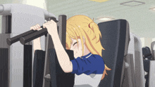 a girl with blonde hair is working out on a machine