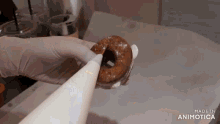 a person is holding a donut in their hand and it says made in animotica