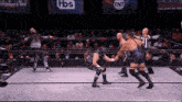 a wrestling match is taking place in front of a tnt banner