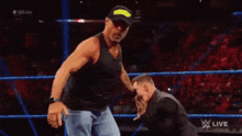 two wrestlers are fighting in a wrestling ring with the words live on the bottom