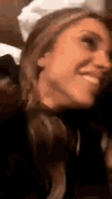 a close up of a woman 's face smiling