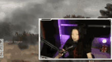 a woman is sitting in front of a microphone with a purple light behind her ..