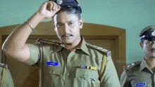 a man in a police uniform with a name tag that says ' t. '