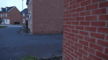 a man squatting down with a pixelated face in front of him