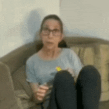 a woman is sitting on a couch with her legs crossed