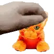 a stuffed cat is sitting under a slipper .