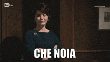 a woman with her arms crossed says che noia in white