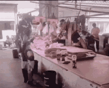 a bottle of aquafina sits on a table in a market