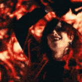 a woman is standing in front of a fire with her arms outstretched .