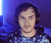 a man wearing headphones and a pixelated shirt