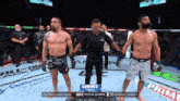 a referee stands between two men in a boxing ring with hart written on his shirt