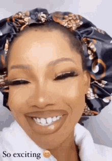 a woman wearing a satin bonnet is smiling with the words so exciting below her .