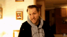 a man wearing a hoodie that says " i 'm not a fan "