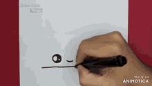 a person is drawing a face on a piece of paper with the words draw cute things on the bottom