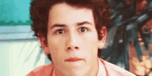 a close up of a young man making a face .