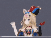 a 3d rendering of a girl wearing a jester hat and waving her hand .