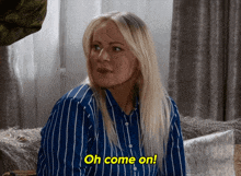 a woman sitting on a couch says oh come on