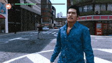a man in a blue shirt is walking down a street in front of a building that says green room
