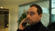 a man with a beard is talking on a phone