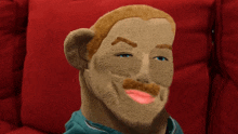 a stuffed animal with a beard and mustache has a pink lip