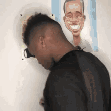 a man is looking through a hole in a wall at a caricature of a man .