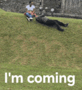 a person laying on the grass with the words i 'm coming written below them