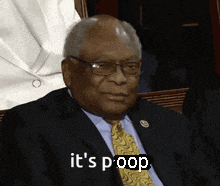 a man in a suit and tie says it 's poop while sitting down