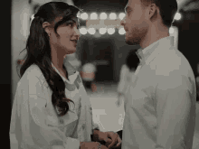 a man and a woman are looking into each other 's eyes