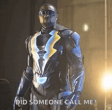 a man in a superhero costume is standing in front of a light .