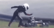 a blurred image of a person in a helmet standing next to a car that says monster on it