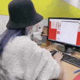 a woman sitting in front of a samsung monitor