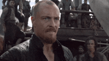 a man with a beard is standing in front of a crowd of people