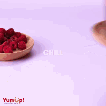 two cakes on plates with raspberries and yumup written on the bottom right