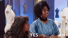 two women are sitting next to each other and one of them is saying " yes "